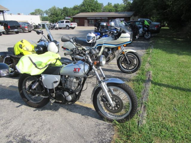 Two pretty nice antique bikes parked side by side.