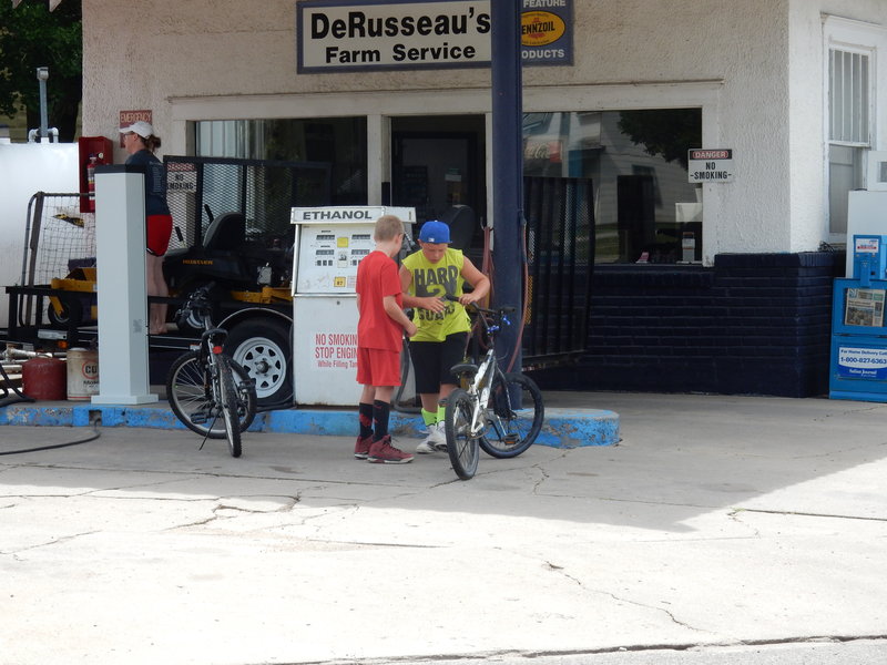 A Norman Rockwell moment "Boys and Bikes at the air hose"