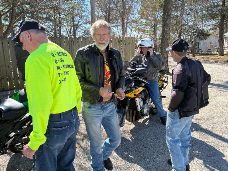 Jim Eickman approaching me to give me a couple solid gold momentos. I will cherish them always. Mike Roland watching Mike Newlun in disbelief as Mike tried for ever to remove his helmet. He finally realized the chin strap was still connected. It happens.