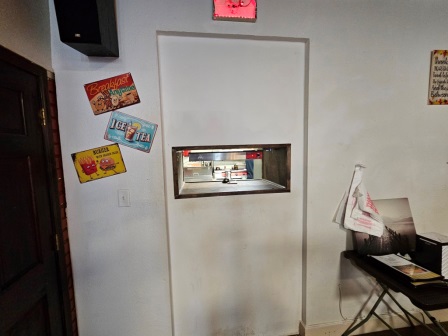 Tiny opening from the kitchen to send food out.